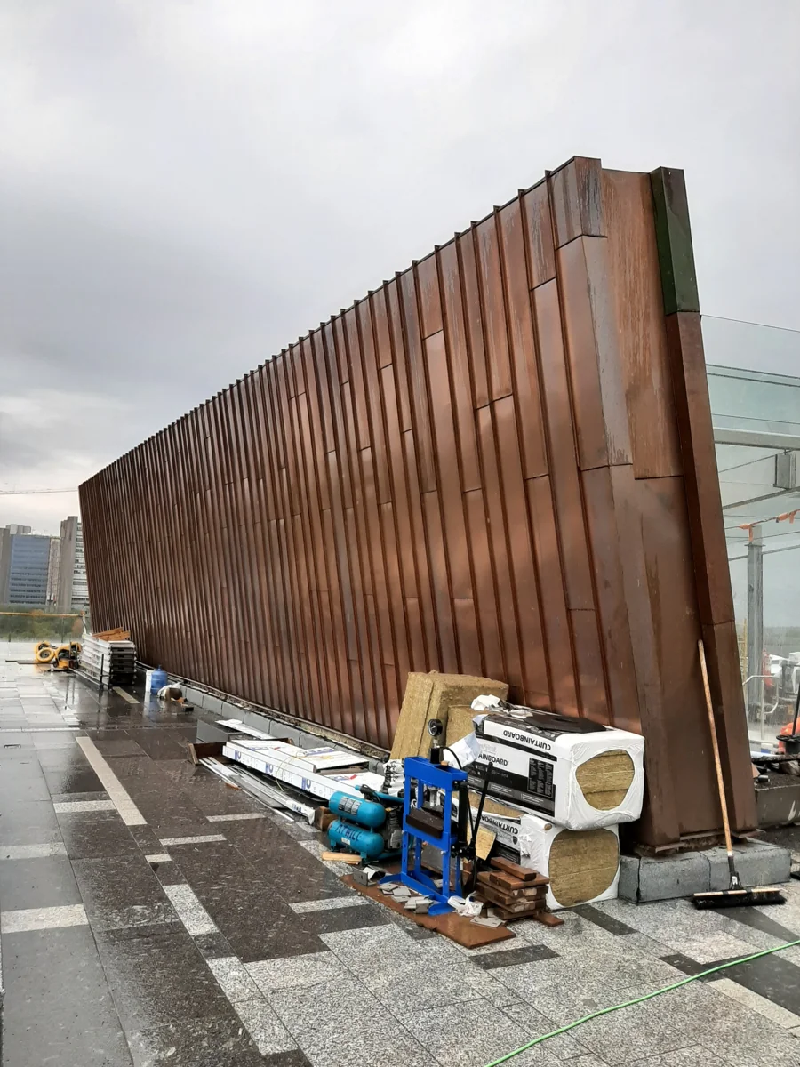 Reclaimed copper panels being installed on an Ottawa façade